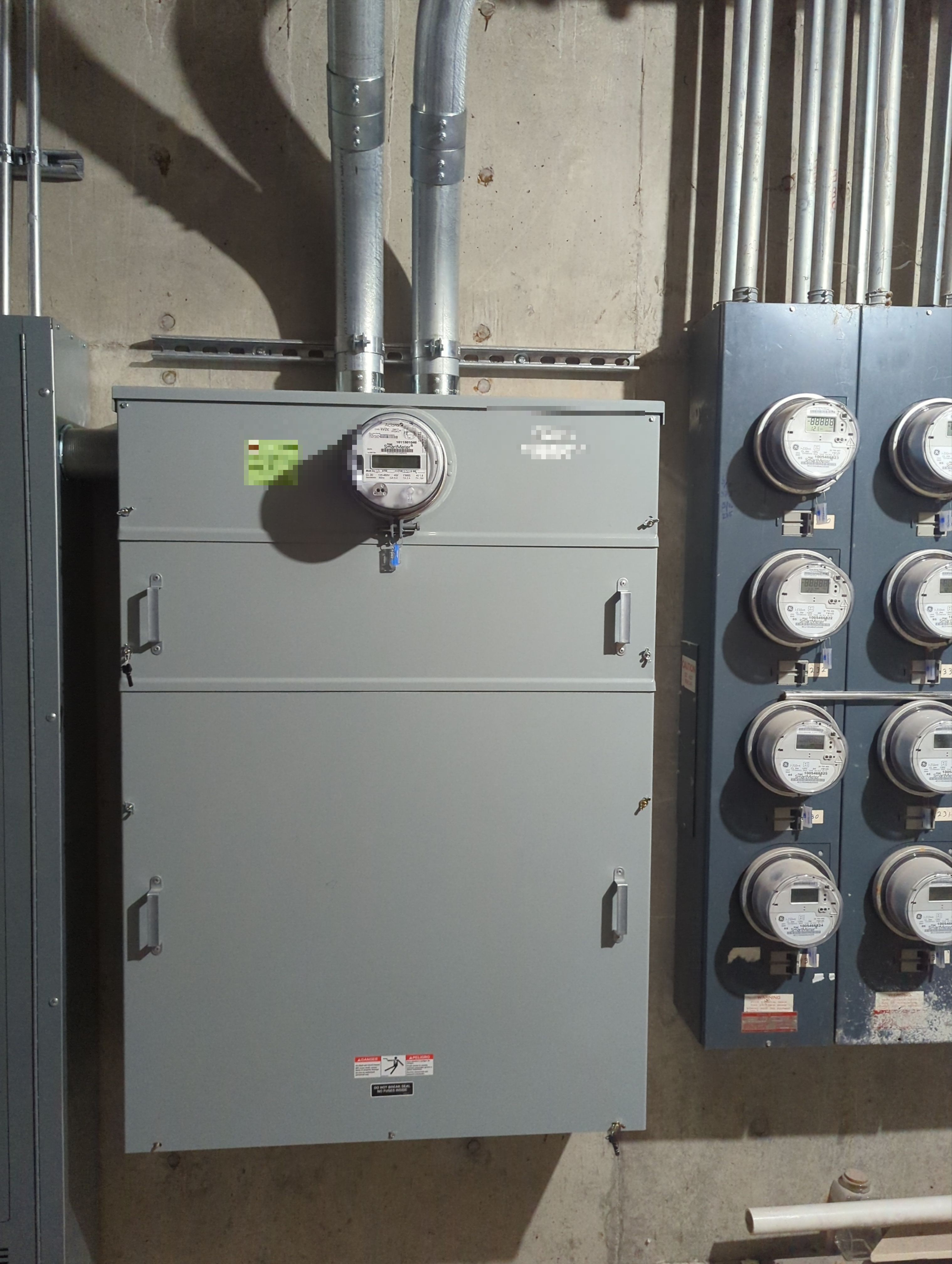 A dedicated GoPower EV meter enclosure beside the building's resident meter bank