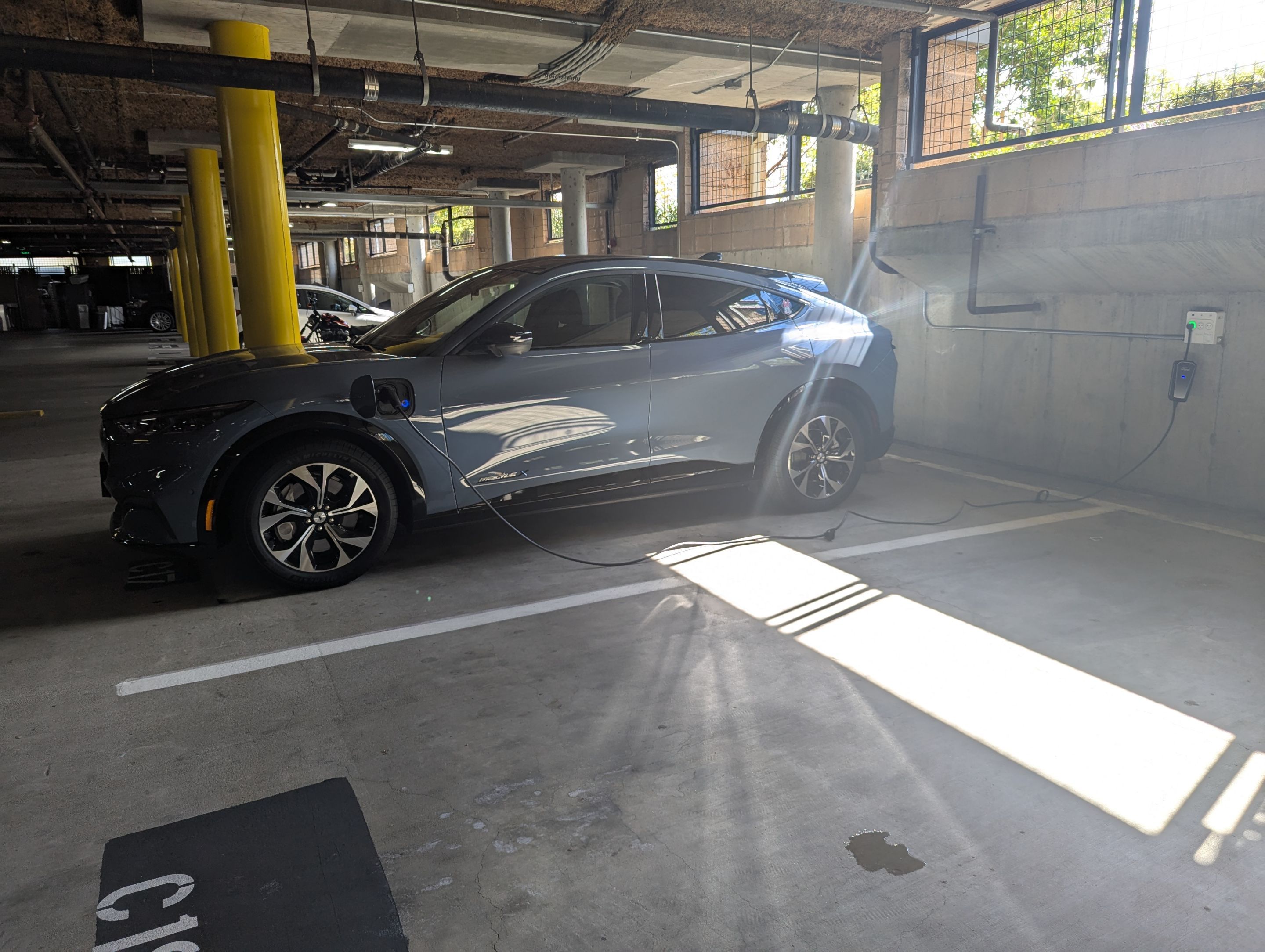 An EV charging at its GoPower port in a resident parking garage